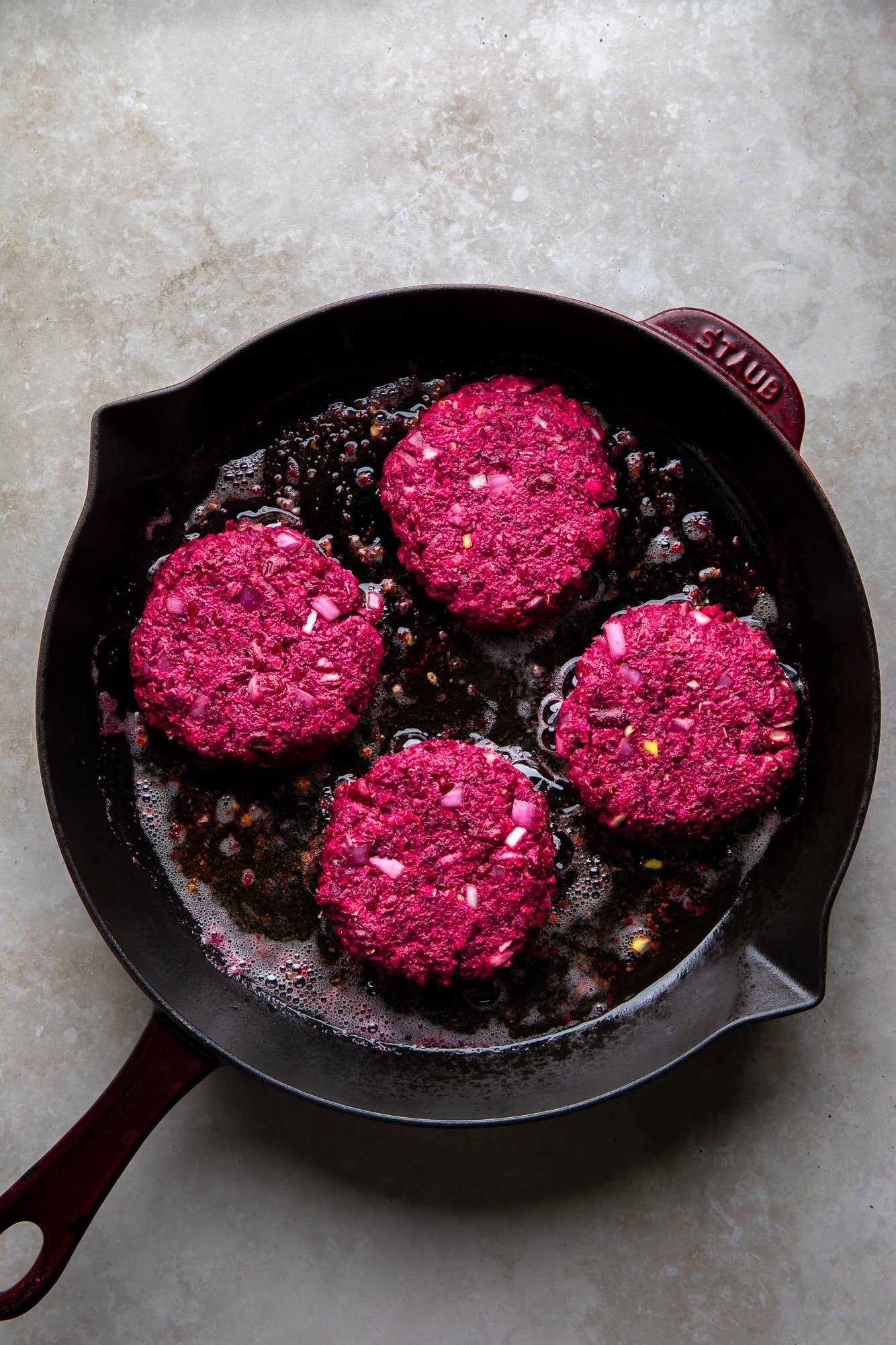 Fry 4 beets burgers in a cast iron pan.