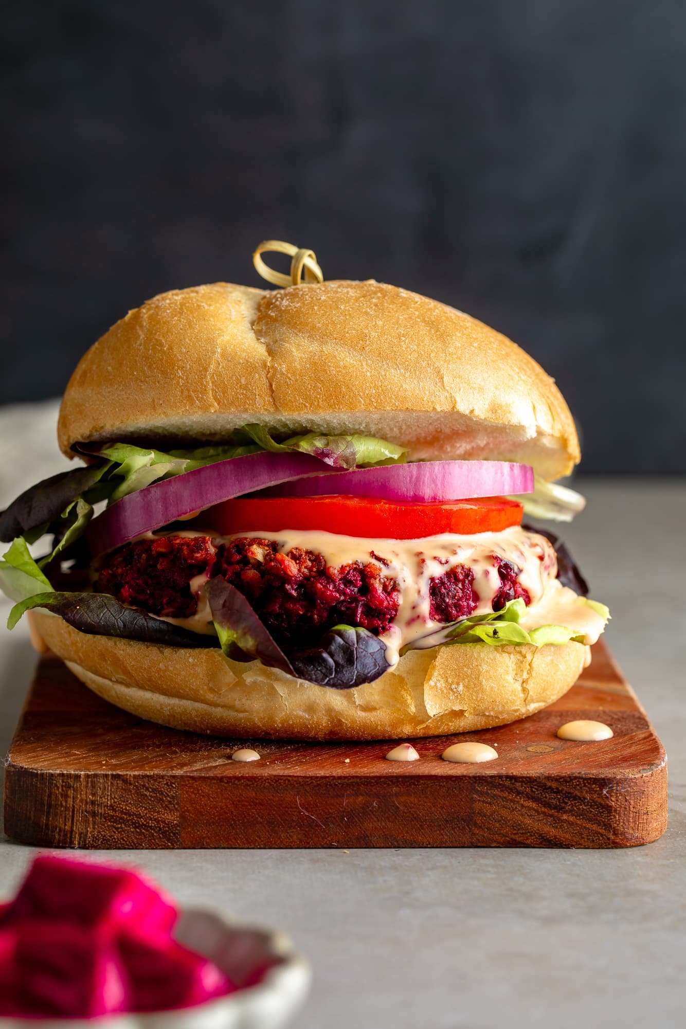 Near a beetroot burger of the kidneys on a bread with accessories.