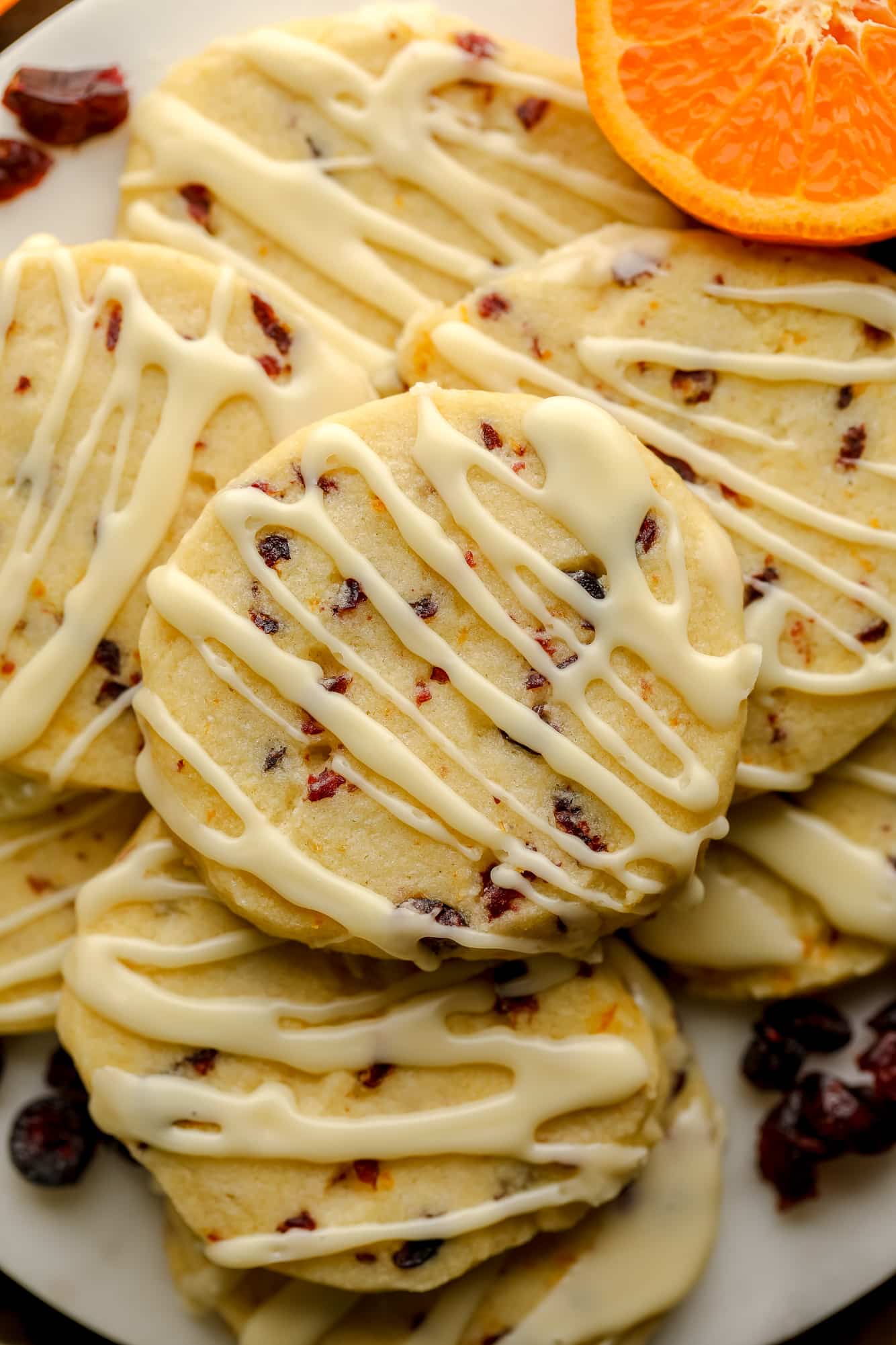 Near a pile of orange bread cookies decorated with orange ice.