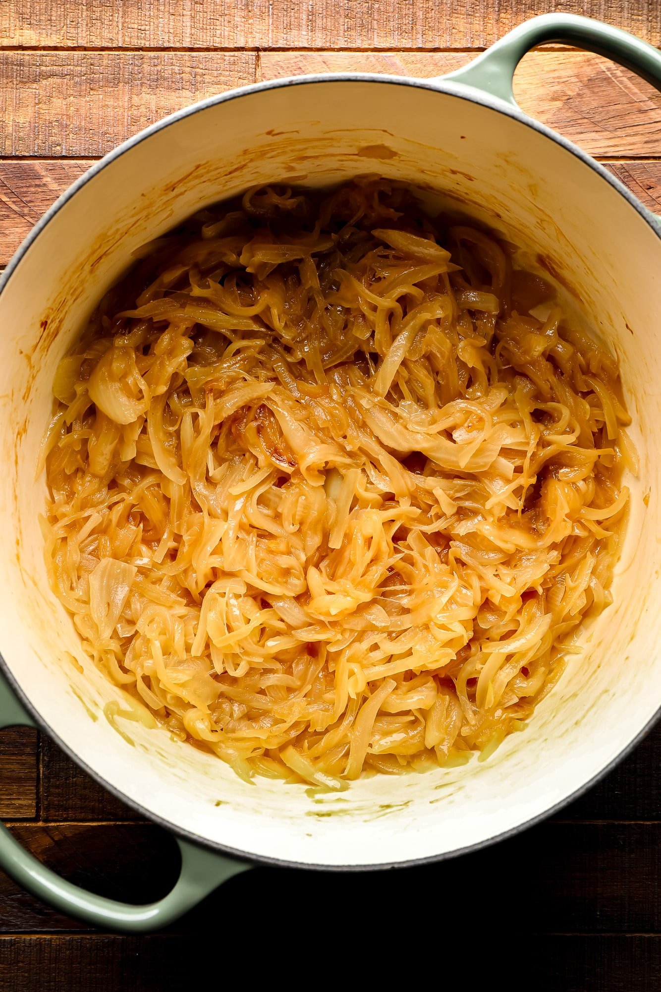 Cook sliced golden onion in a large pot.