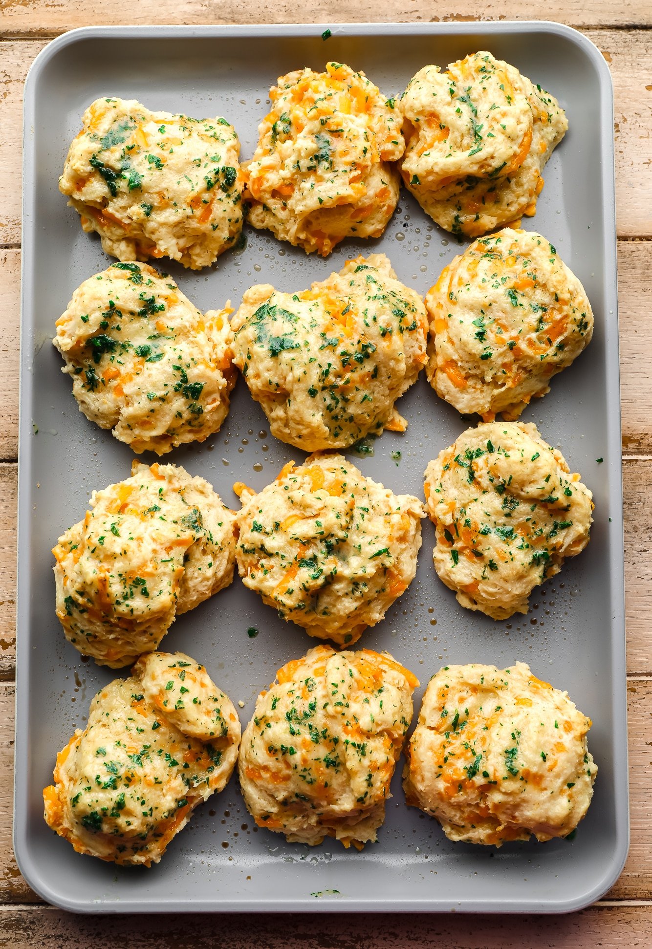 Bay bakery cookies in the oven, topped with parsley in a metal oven leaf.