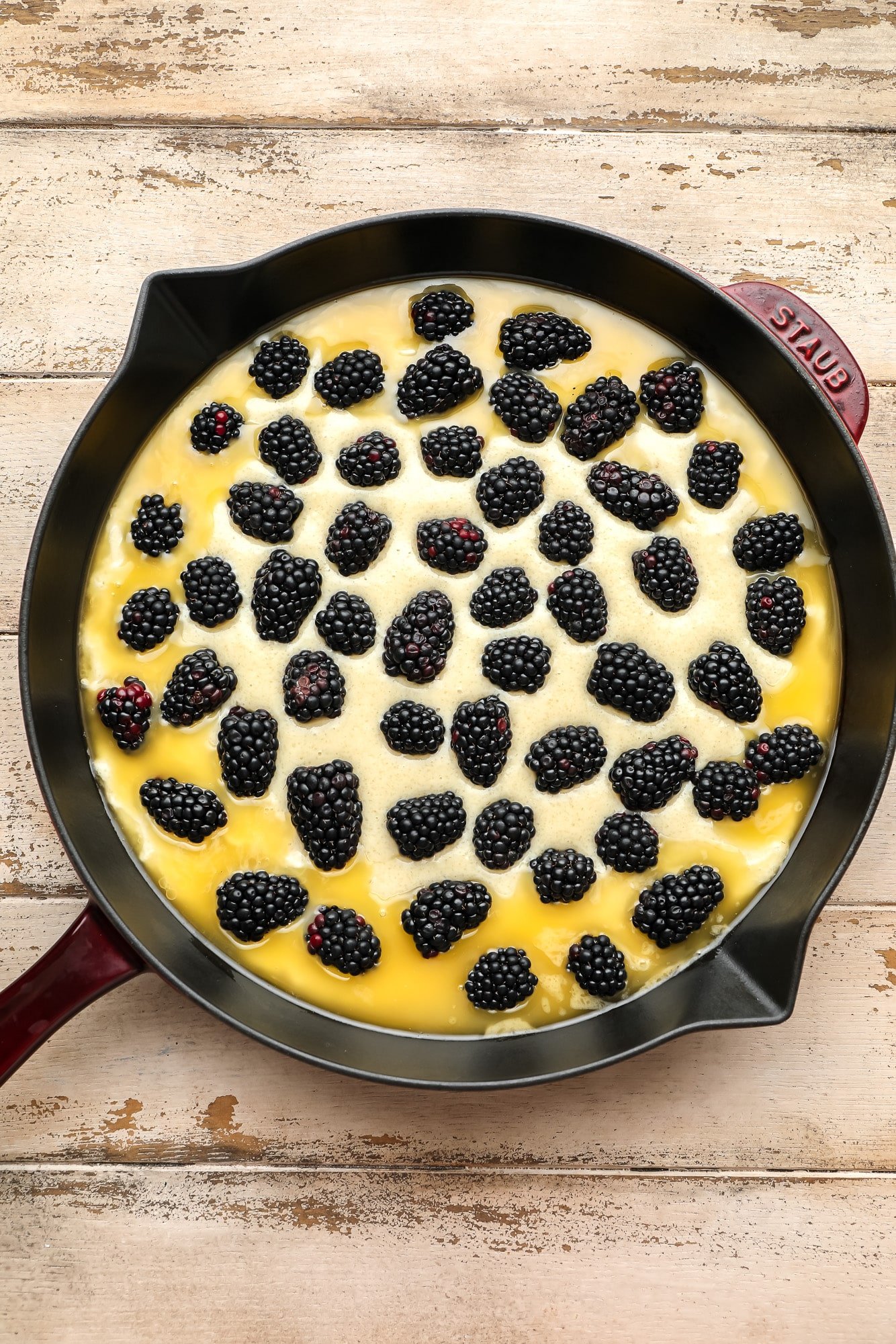 A blackberry cobbler unborn and mounted in a black paella.