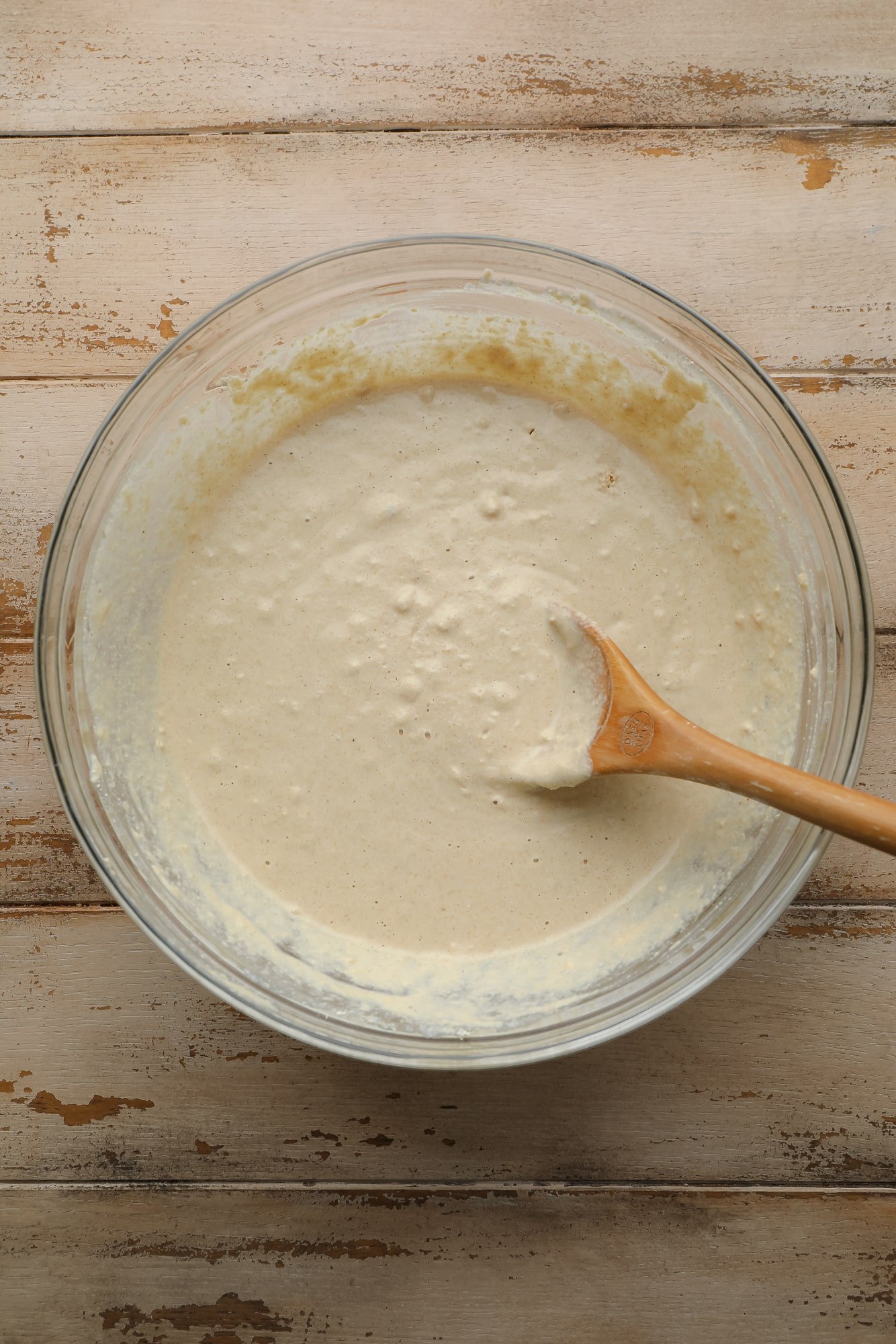 Use a wooden spoon to stir oatmeal flour in a large bowl.