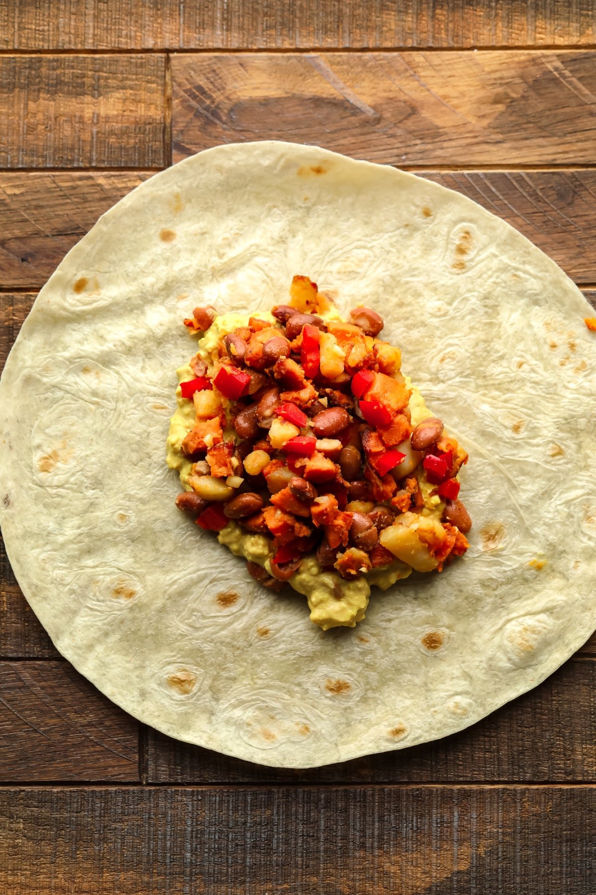 Tortilla on wooden board with vegetable potato beans and mix Eggy